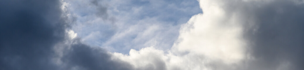 Reflection of blue sky and white and gray clouds on smooth water of Lake Washington, as an abstract nature background
