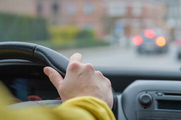 Emergency braking by car. Windshield and perspective of the road. Steering. Selected Focus. Hand of woman on a car steering wheel