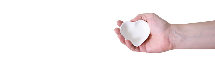 Obraz premium A hand with a heart-shaped saucer on a white background.
