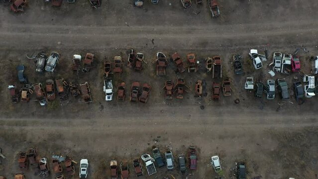 Bottom up aerial cenital shot  from a abandonated car junk