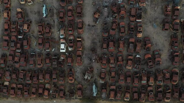 Close up aerial cenital shot left to right from a abandonated car junk