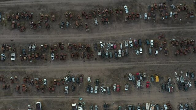 Aerial cenital shot left to right from a abandonated car junk