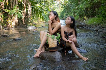 Portrait of beautiful two young Asian girls in river