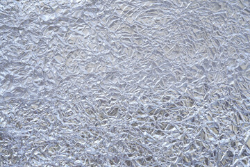 crumpled aluminum foil close-up background blurry or blurry images