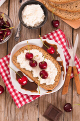 Rye bread with cottage cheese and cherries.