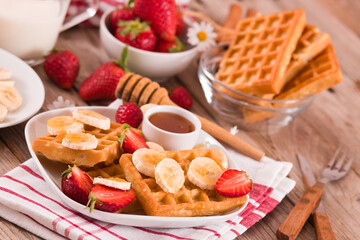 Waffles with strawberries, bananas and honey.