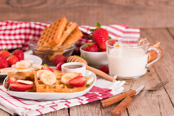 Waffles with strawberries, bananas and honey.