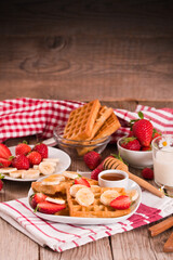 Waffles with strawberries, bananas and honey.