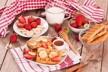 Waffles with strawberries, bananas and honey.