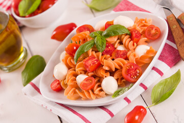 Fusilli pasta with cherry tomatoes and mozzarella cheese.