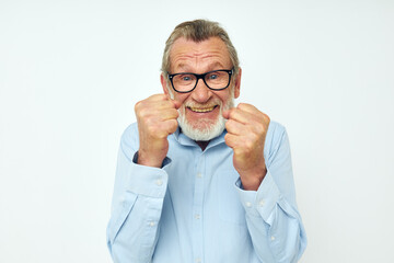 Portrait of happy senior man in shirt and glasses posing emotions cropped view