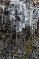 Icicles forming an icefall in the mountain in winter.