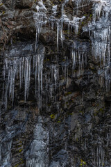 Icicles forming an icefall in the mountain in winter.