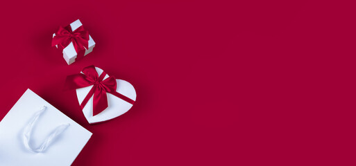 Banner with a gift box in the shape of a heart on a red background. Valentine's Day gift concept,...