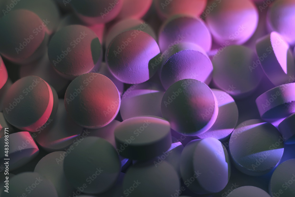 Poster pills or drugs in a package under neon light. beautiful background pattern for design.