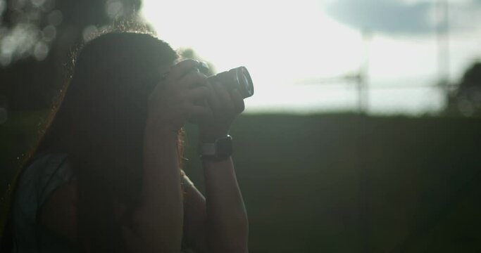 woman with a camera. girl taking photo. photographer girl. silhouette of a person