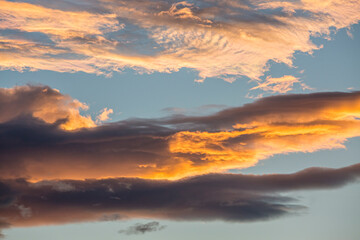 Colorful orange and blue dramatic sky with clouds for abstract background over Graz, Austria.