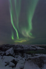 At night in winter, the tundra and the aurora borealis.