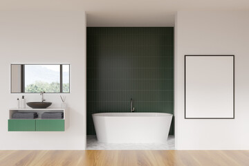 Fototapeta na wymiar Modern bathroom interior with white ceramic bathtub, sink. Green tile on walls, hardwood flooring. Blank framed poster on wall. Mockup. 3d rendering.