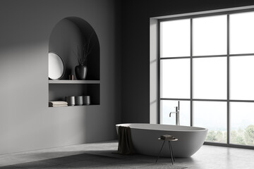 Modern bathroom interior with white ceramic bathtub. Gray walls, concrete flooring. Panoramic window. No people. 3d rendering.