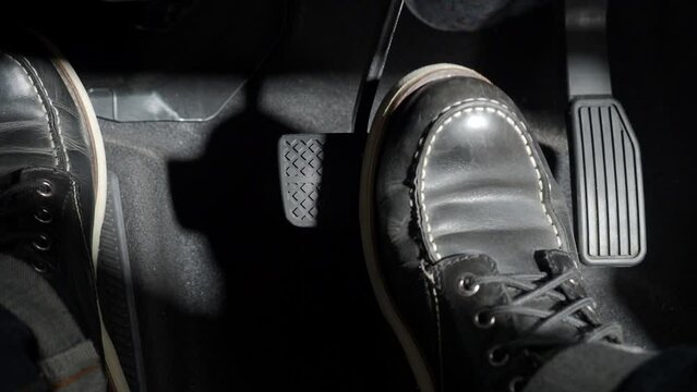 Accelerate and Brake. Foot pressing foot pedal of a car to drive ahead. Accelerator and brake pedal in a car. Driver driving the car by pushing accelerator pedals of the car. inside vehicle automobile