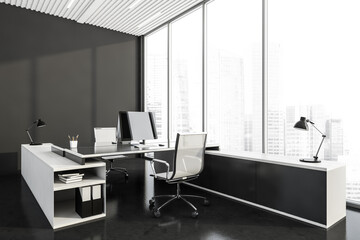 Corner view of dark grey office room interior with two workplaces and panoramic windows
