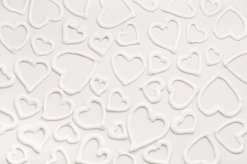 sweet meringue kiss cookies of heart shapes over white background, concept of St. Valentines Day, make up