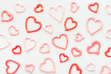 sweet meringue kiss cookies of heart shapes on white background, concept of St. Valentines Day