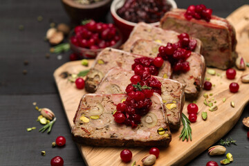 Sliced Traditional French terrine covered with bacon on dark wooden background