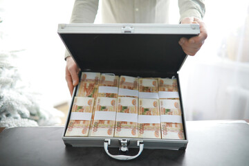 A metal suitcase filled with Russian banknotes of 5000 rubles. Investment, bribe, corruption...