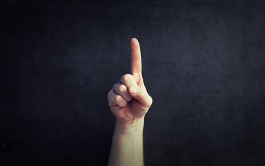 Finger gestures. Male hands on a gray background. Gesticulation with hands.