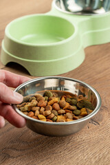 bowl for cat food on a wooden background. double bowl for water and cat food
