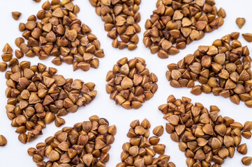 buckwheat on a white background, buckwheat porridge, snowflake from buckwheat grains, flower from cereals