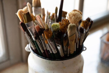 Bunch of paint brushes in metal bucket close up. Artist paintbrushes pack for drawing in oil,...