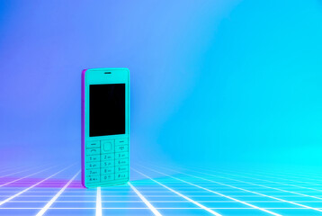 Retro cell phone vintage concept. White old mobile telephone in neon pink blue light. Retro wave....