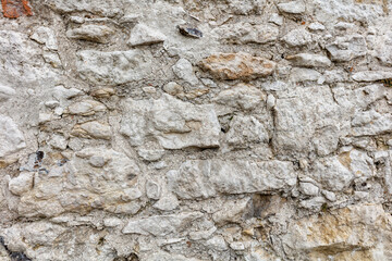 Obraz na płótnie Canvas Fragment of an old gray stone wall old gray masonry
