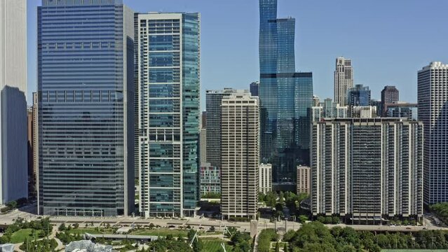 Chicago Illinois Aerial v61 establishing shot drone flying through high rise residential and office buildings at new eastside from maggie daley park capturing modern downtown cityscape - August 2020