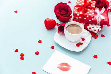 White cup of coffee with gift and roses. morning breakfast. Holiday background. Greeting card....
