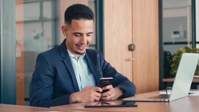 4k footage of a businessman using a cellphone while sitting in his office 