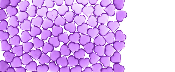 St Valentines day violet lilac background full frame. Many glass hearts flat lay. Love or wedding concept on white isolated
