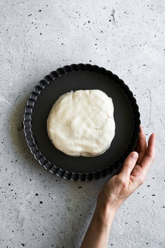 A baker making a tart shell