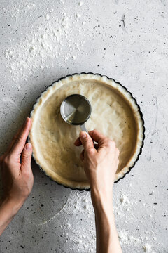 A baker making a tart shell
