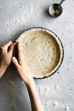 A baker making a tart shell