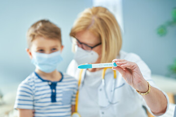 Pediatrician doctor examining little kids in clinic covid test