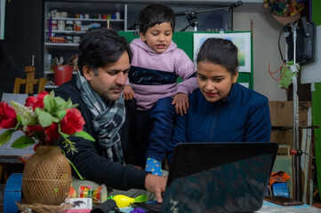 parents teaching our child from laptop .