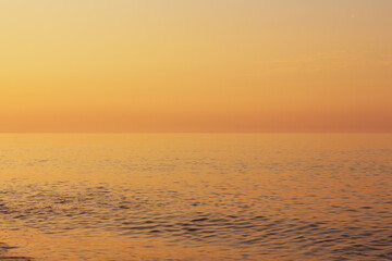 Beautiful sunset on the rocky beach . Soft peaceful water composition
