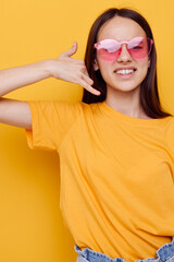 young beautiful woman in a yellow t-shirt emotions summer style isolated background