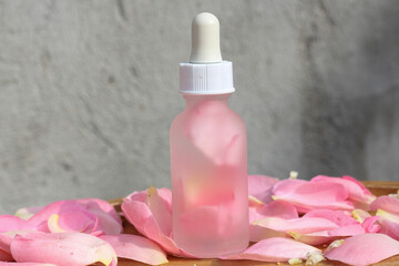 Beauty product bottle with pure rose essential oil for spa treatment and relaxation. Natural body care commercial idea