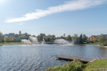 Fototapeta na wymiar Water fountains in pond in Zambrow, Poland.