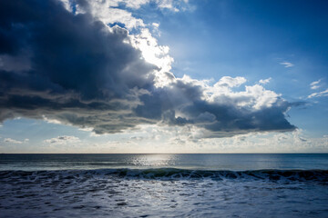 Cloudy seascape view from a beach at sunset
